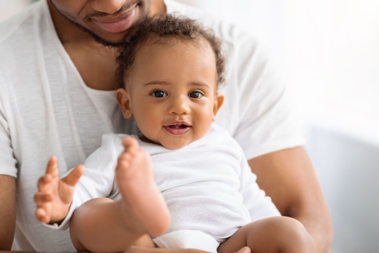 Portrait Of Adorable Black Baby Boy Spending Time With Father At Home