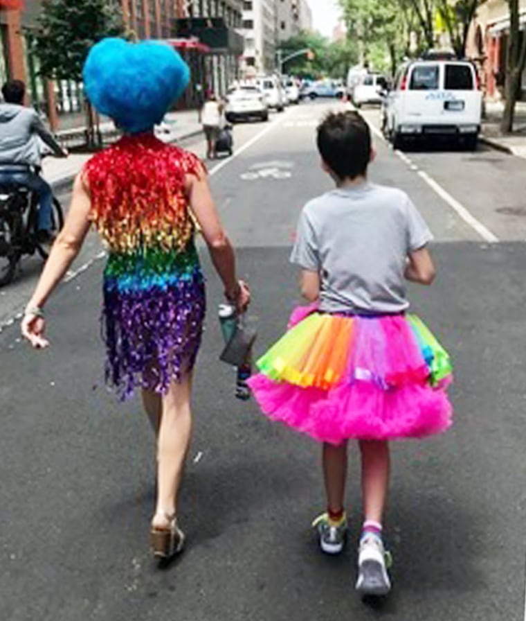 Cacophony pictured with their son, celebrating Pride in New York City.