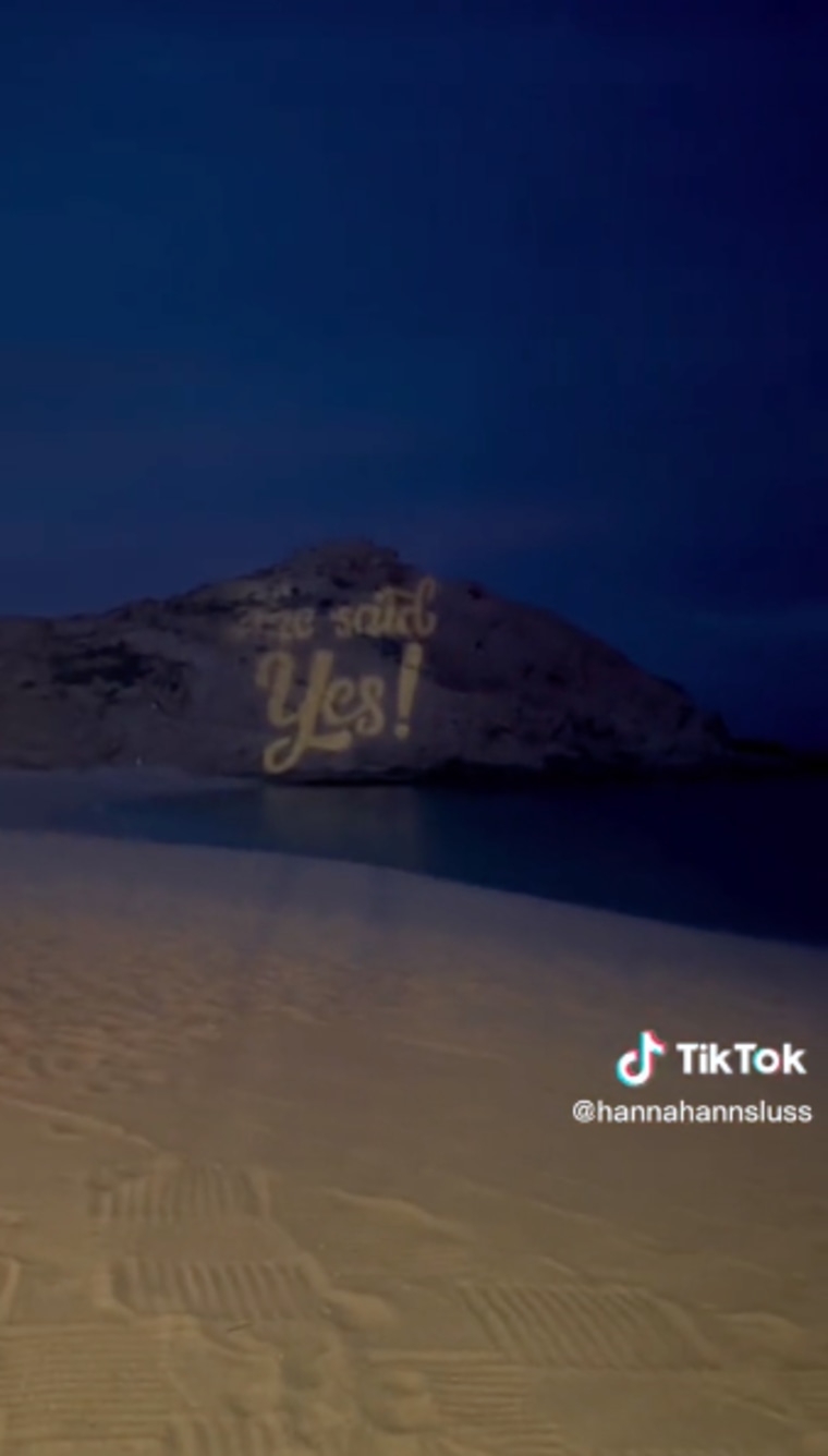"She said yes" was projected on a large rock after the proposal.