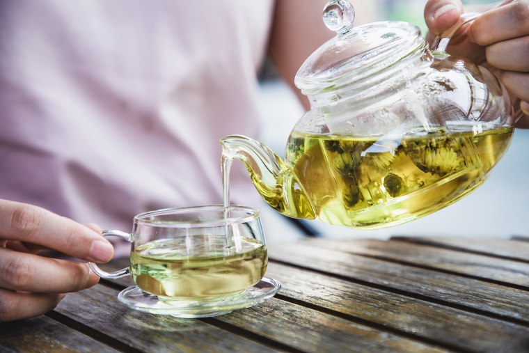 Pouring a cup of herbal tea.