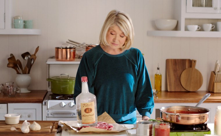 Martha tenderizes meat with her Tito's bottle.