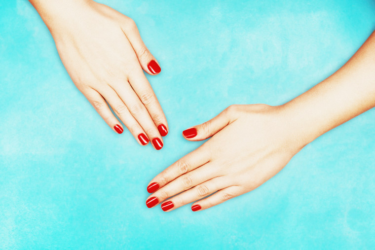 Cropped Image Of Hands With Red Nail Polish