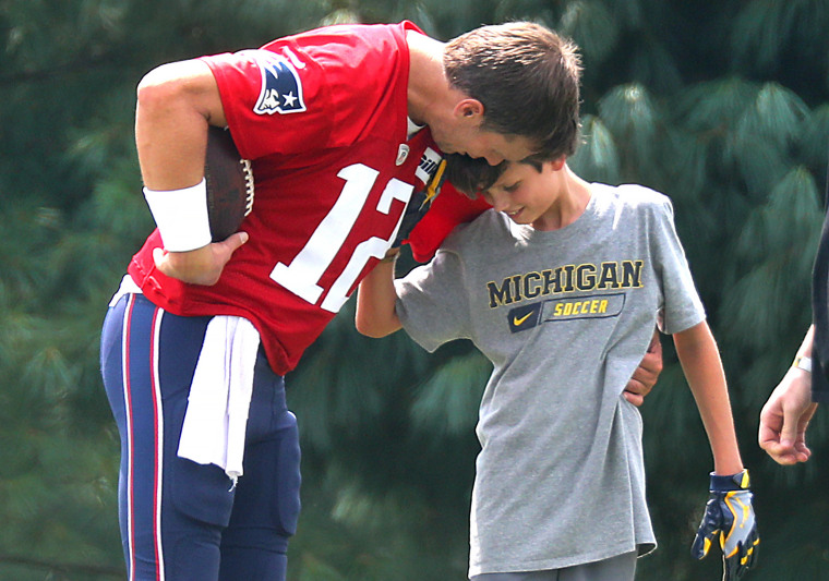 Tom Brady with his oldest son, Jack, as he was throwing him some passes after New England Patriots training camp in 2018.