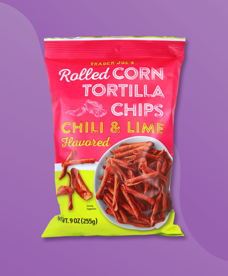 A bag of Trader Joe's Chili & Lime Flavored Rolled Corn Tortilla Chips on a purple background.