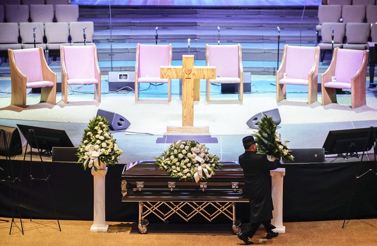Image: A man arranges flowers around Tyre Nichols' casket at Mississippi Boulevard Christian Church in Memphis, Tenn., on Feb. 1, 2023.