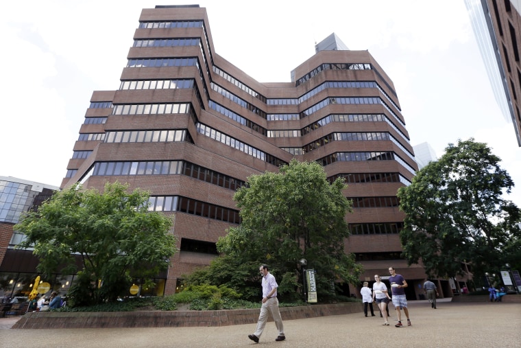 People walk outside Vanderbilt University Medical Center, Tuesday, July 16, 2013, in Nashville, Tenn. The hospital has announced it will offer early retirement as one way to reduce costs as the hospital seeks to close a $70 million revenue shortfall this fiscal year.