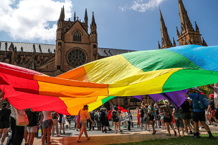 Protesters hold a giant rainbow flag outside St Mary's Cathedral ahead of the pontifical requiem Mass for Cardinal George Pell on February 02, 2023 in Sydney, Australia.