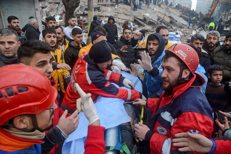Rescue workers and volunteers pull a survivor from the rubble in Diyarbakir, Turkey, on Feb. 6, 2023. 