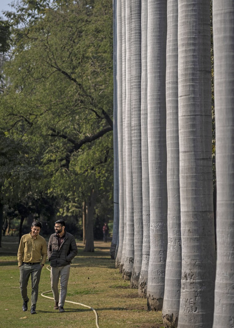 Utkarsh Saxena, left, and Ananya Kotia walk through a public park in New Delhi, India, on Jan. 18, 2023. 