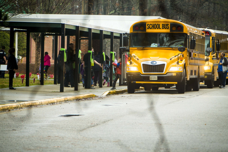 Students exit a school bus during the first day back to Richneck Elementary School on Monday Jan. 30, 2023 in Newport News, Va.  The Virginia elementary school where a 6-year-old boy shot his teacher has reopened with stepped-up security and a new administrator.