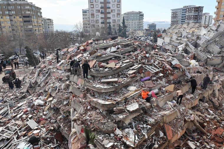 Hancer sat quietly as others searched the rubble for survivors in the building where she was killed.