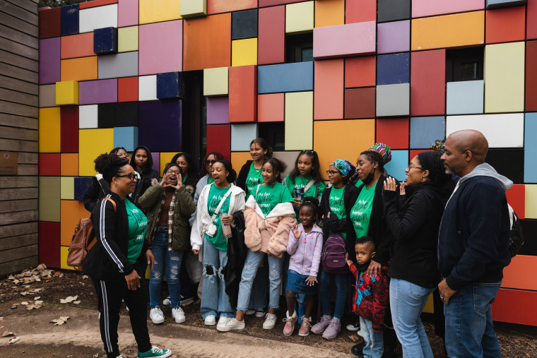 Home Grown Homeschoolers Inc. co-op founder Tralandra Stewart, left, leads members in a chant in Discovery Green Park in Houston, Texas at the end of field trip day on Jan. 27, 2023.