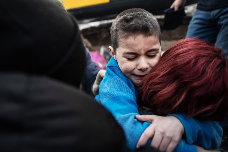 Yigit Cakmak, an eight year old survivor at the site of a collapsed building, hugs his mother, after workers rescued him 52 hours after the earthquake struck, on February 08, 2023 in Hatay, Turkey. 