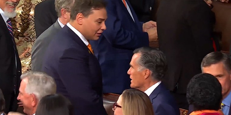 Rep. George Santos, R-N.Y., speaks with Sen. Mitt Romney, R-Utah, before the start of the State of the Union address at the U.S. Capitol on Tuesday.