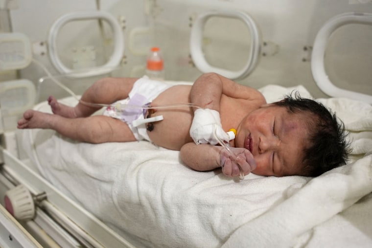 A newborn baby receives medical care on Feb. 7, 2023, after being rescued from the rubble of a home in northern Syria.