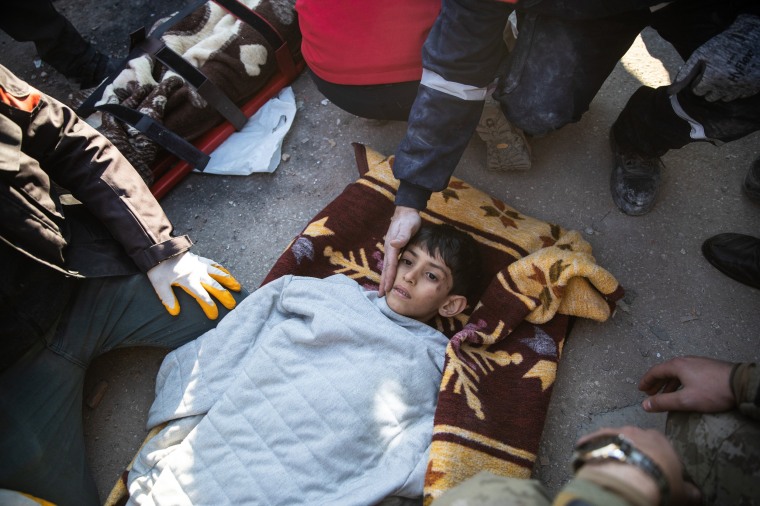 Rescue workers tend to Ahmet Findik, an 11-year-old survivor, at the site of a collapsed building 60 hours on from the earthquake on February 8, 2023 in Hatay, Turkey. 