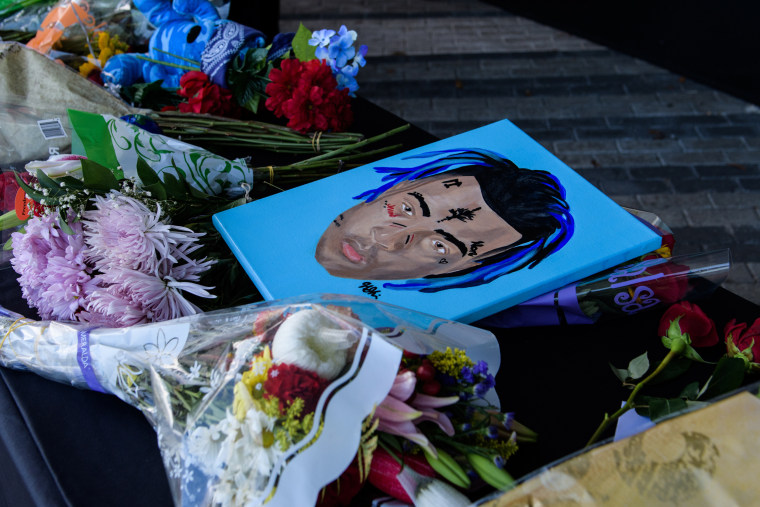 Fans leave items at a memorial outside the XXXTentacion Funeral & Fan Memorial