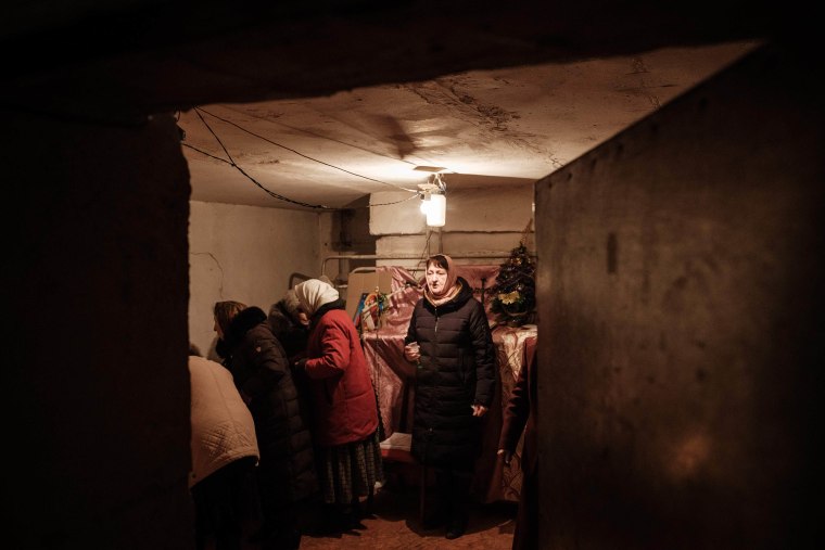 Orthodox Christians attend the Sunday prayer at the basement of an apartment in Chasiv Yar, Ukraine on Feb. 5, 2023.