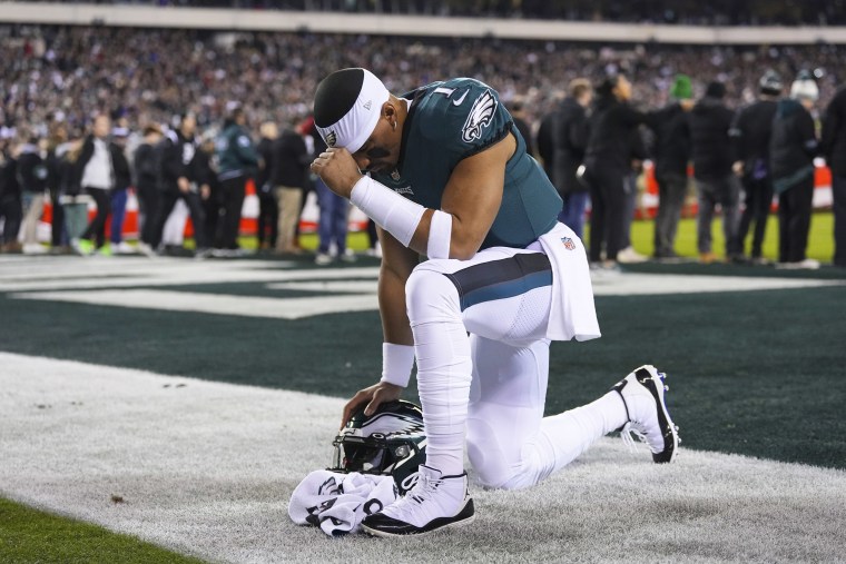 A member of the Philadelphia Eagles prays during a football game in Philadelphia