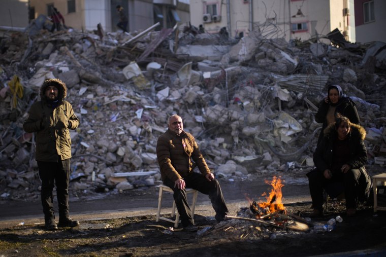 Tens of thousands of people who lost their homes in a catastrophic earthquake huddled around campfires in the bitter cold and clamored for food and water Thursday, three days after the temblor hit Turkey and Syria. 