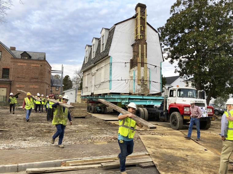 Workers prepare to move the original structure that held what is believed to be the oldest schoolhouse in the U.S. for Black children