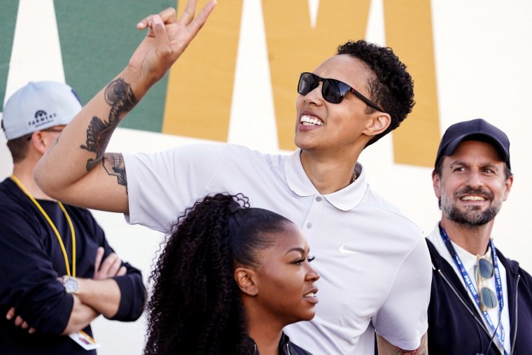 Brittney Griner acknowledges fans as she watches on the 16th hole during the third round of the Phoenix Open golf tournament on Feb. 11, 2023, in Scottsdale, Ariz.