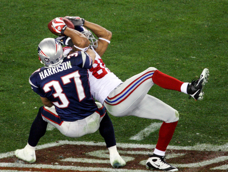New York Giants' wide receiver David Tyree pins the ball to his helmet as he catches a 32-yard pass late in the fourth quarter of Super Bowl XLII against the New England Patriots at the University of Phoenix Stadium in Phoenix on Feb. 3, 2008.