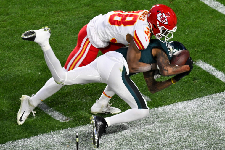 Philadelphia Eagles' wide receiver DeVonta Smith catches the ball and gets tackled by Kansas City Chiefs' cornerback L'Jarius Sneed during Super Bowl LVII on Feb. 12, 2023, in Glendale, Ariz.