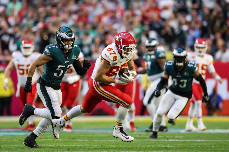 Travis Kelce #87 of the Kansas City Chiefs carries the ball against the Philadelphia Eagles during the first quarter of Super Bowl LVII on Feb. 12, 2023, in Glendale, Ariz.