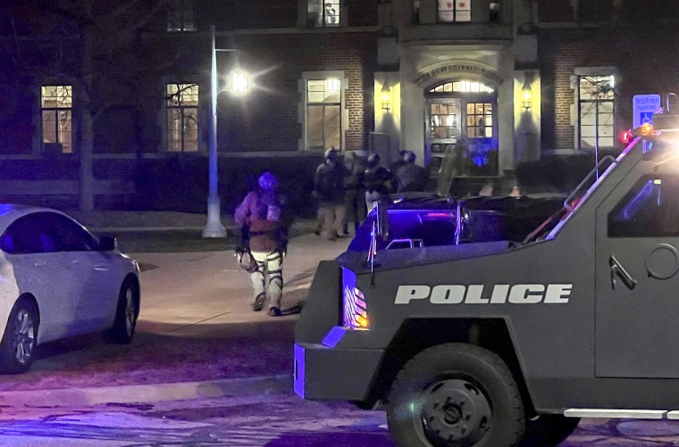 Image: Police officers with weapons drawn enter Phillips Hall at Michigan State University in East Lansing after reports of a shooting on campus on Monday.