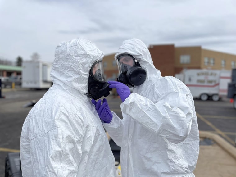 ONG 52nd Civil Support Team members prepare to enter an incident area to assess remaining hazards with a lightweight inflatable decontamination system in East Palestine, Ohio