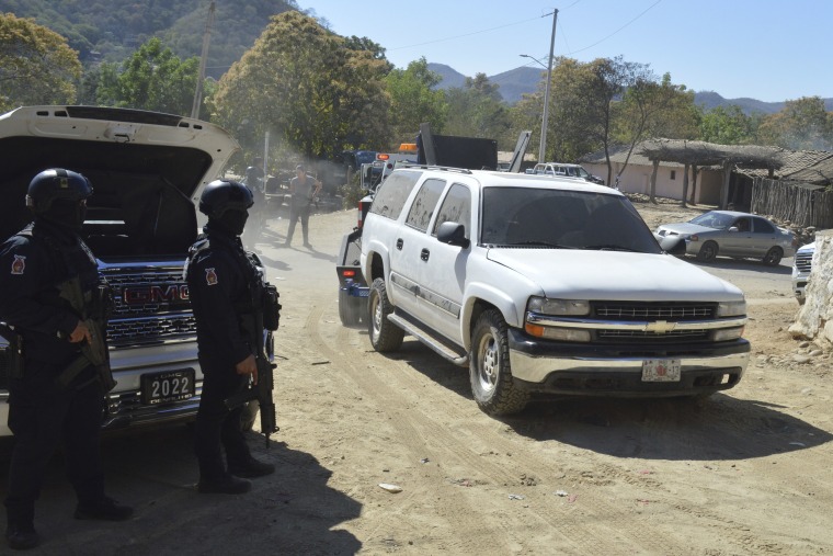 Members of the Sinaloa state police remove abandoned vehicles from the roads of Jesus Maria, Mexico, on Saturday, Jan. 7, 2023, the small town where Ovidio Guzman was detained earlier in the week. Thursday's government operation to detain Ovidio, the son of imprisoned drug lord Joaquin "El Chapo" Guzman, unleashed firefights that killed 10 military personnel and 19 suspected members of the Sinaloa drug cartel, according to authorities. 