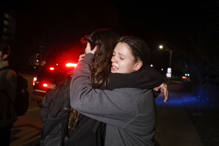 Image: Michigan State University students hug during an active shooter situation in Lansing on Monday.