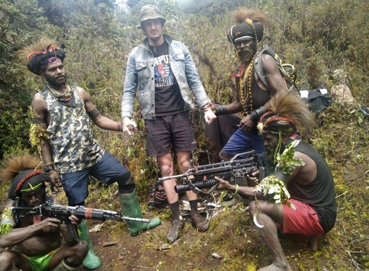 Papuan separatist rebels pose for a photo with a man they said is New Zealander pilot Phillip Mark Mehrtens at an undisclosed location in Papua province, Indonesia. 