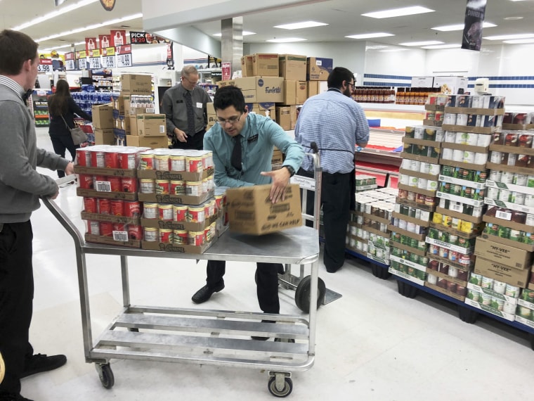 Employees stock products at a Hy-Vee supermarket in Omaha, Neb.