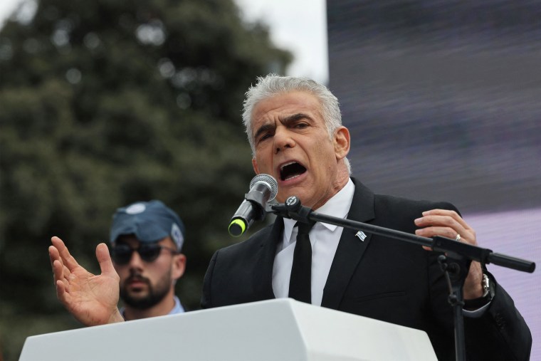 Israel's opposition leader, former Prime Minister Yair Lapid, addresses protesters outside the Knesset in Jerusalem on Monday. 