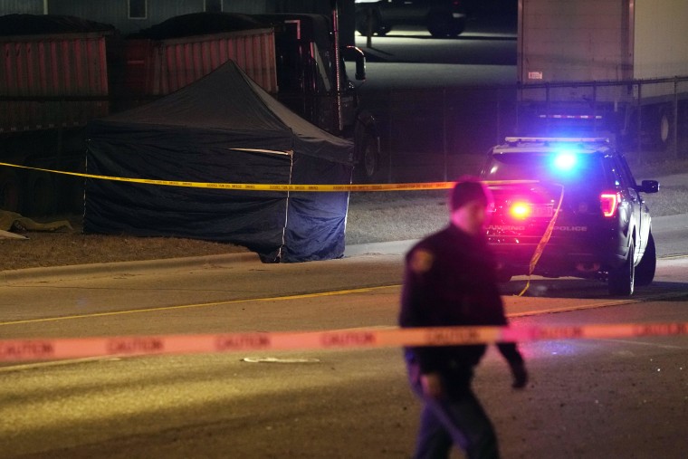A tent covers the body of a gunman on Feb. 14, 2023, in Lansing, Mich., who opened fire Monday night at Michigan State University.