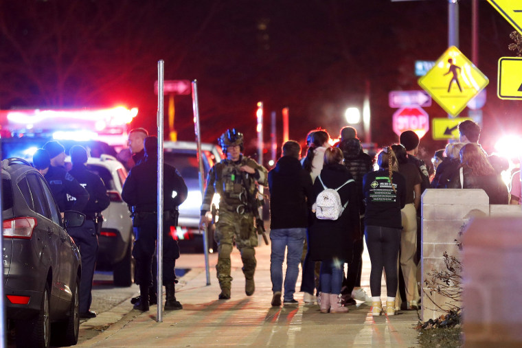 Students gather on the campus of Michigan State University in East Lansing, Mich. after a shelter in place order was lifted 