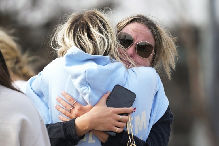 Students hug on the Michigan State University campus in East Lansing, Mich.