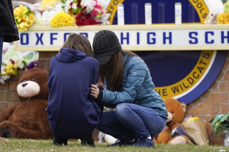 Mourners grieve at Oxford High School in Oxford, Mich.