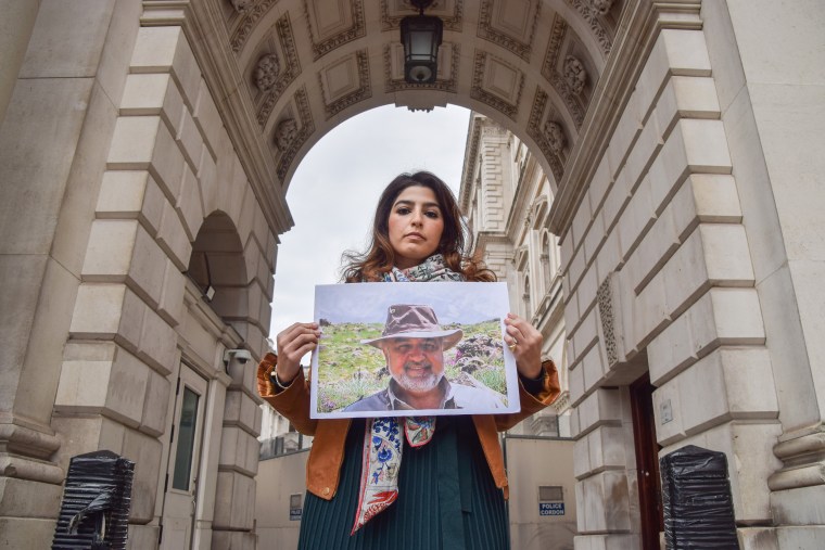 Roxanne Tahbaz holds a picture of her father Morad Tahbaz in London