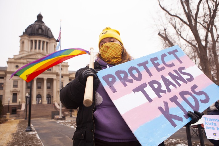 People protest a bill that would bar transgender girls from playing on sports team that match their gender identity outside the state capitol in Pierre, S.D., on Jan. 15, 2022.