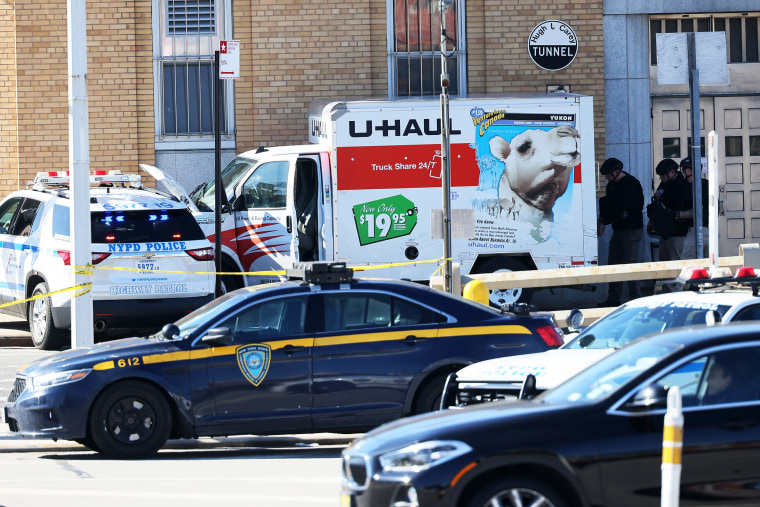 NYPD officers search a crashed U-Haul truck on Hamilton Avenue in Brooklyn, N.Y