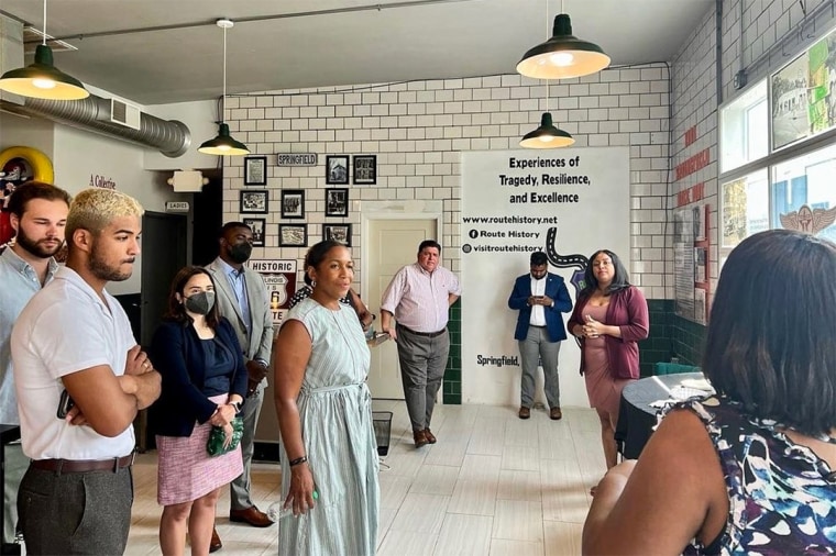 Gina Lathan, right, leads a Route History tour for Illinois Gov. J.B. Pritzker, Lt. Gov. Juliana Stratton, and staff from the Illinois Department of Commerce and Economic Opportunity.