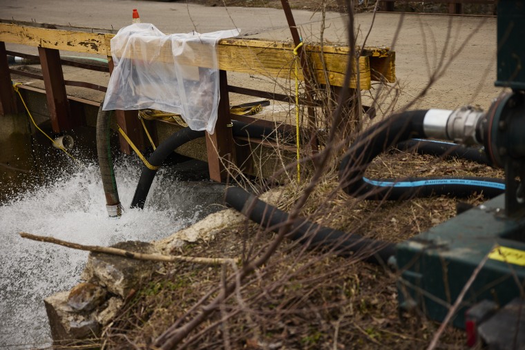 Water is pumped into a creek for aeration on Feb. 14, 2023 in East Palestine, Ohio.