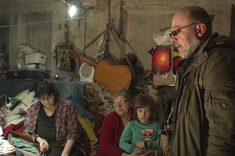 The makeshift shelter where the Anapolska family has lived for almost six months. Serhiy Chaus, right, the town's unofficial mayor, has been supplying residents with food and medicine.