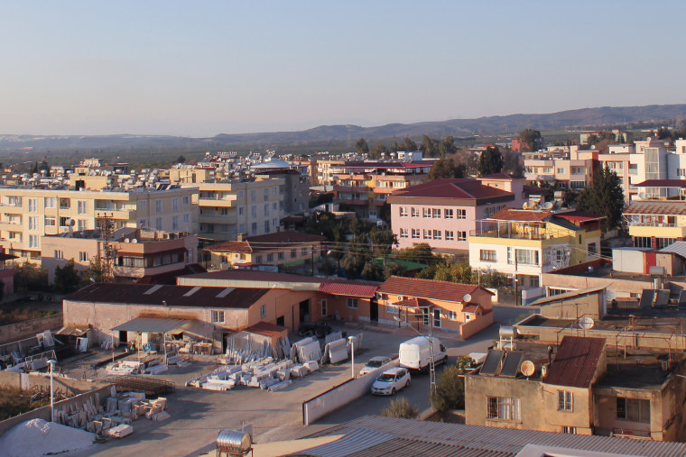 Buildings stand in the center of Erzin on Tuesday. 