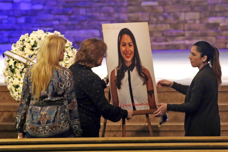 Women set up a picture of Paris attack victim Nohemi Gonzalez for her funeral service at the Calvary Chapel in Downey, Calif., on Dec. 4, 2015. 