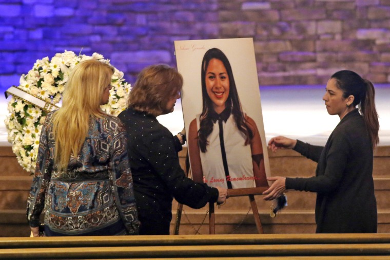 Women set up a picture of Paris attack victim Nohemi Gonzalez for her funeral service at the Calvary Chapel in Downey, Calif., on Dec. 4, 2015.