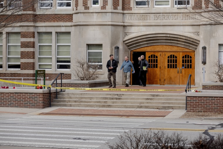 Investigators leave the scene of a shooting at Berkey Hall at Michigan State University in Lansing, Mich.